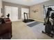 Home gym including work-out equipment, sliding doors, and neutral colored walls and floors at 6693 W May Apple Dr, McCordsville, IN 46055