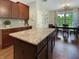 Spacious kitchen featuring a large center island, warm wood cabinetry, and adjoining dining area at 6693 W May Apple Dr, McCordsville, IN 46055