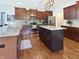 Stylish kitchen with stainless steel appliances, center island, and warm wood cabinetry for a modern design at 6693 W May Apple Dr, McCordsville, IN 46055
