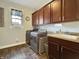 Functional laundry room with washer, dryer, cabinets, and sink at 6693 W May Apple Dr, McCordsville, IN 46055