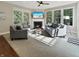 Comfortable living room with fireplace, large windows, ample seating, and abundant natural light at 6693 W May Apple Dr, McCordsville, IN 46055