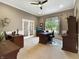 Well-lit home office with multiple desks, neutral walls, and a ceiling fan, perfect for productivity at 6693 W May Apple Dr, McCordsville, IN 46055