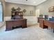 Spacious home office featuring dark wood furniture, neutral tones, and ample workspace for productivity at 6693 W May Apple Dr, McCordsville, IN 46055