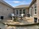 Covered patio includes an outdoor seating area with a stone firepit at 6693 W May Apple Dr, McCordsville, IN 46055