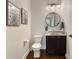 Chic powder room featuring a modern vanity, stylish mirror, and decorative artwork at 6693 W May Apple Dr, McCordsville, IN 46055