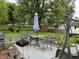 The home's backyard has a great entertainment space with a dining set, grill, and lush greenery at 670 Van Ave, Shelbyville, IN 46176