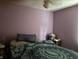 A bedroom boasts vibrant purple walls and a comfortable bed, creating a relaxing retreat at 670 Van Ave, Shelbyville, IN 46176