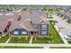 An aerial view of the townhome featuring blue siding, a brown roof, and a well-manicured lawn at 7077 Antiquity Dr, Carmel, IN 46033
