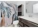 Modern bathroom featuring a dark vanity, toilet, linen closet, and stylish shower curtain at 7077 Antiquity Dr, Carmel, IN 46033