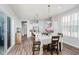 Bright dining area featuring a stylish table setting, modern light fixture, and an open view to the kitchen at 7077 Antiquity Dr, Carmel, IN 46033