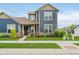 Charming two-story home featuring blue siding, a welcoming front porch, and meticulously maintained landscaping at 7077 Antiquity Dr, Carmel, IN 46033