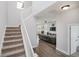 Bright foyer with a staircase leading to the upper level and open view to the living space at 7077 Antiquity Dr, Carmel, IN 46033