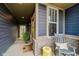 Inviting front porch with a rocking chair, decorative stool, and a welcoming sunflower door mat at 7077 Antiquity Dr, Carmel, IN 46033