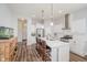 Bright kitchen showcasing an island with seating, stainless steel appliances, and stylish pendant lighting at 7077 Antiquity Dr, Carmel, IN 46033