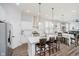 Open-concept kitchen with island seating, modern appliances, and seamless flow into the adjacent dining area at 7077 Antiquity Dr, Carmel, IN 46033