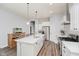 Modern kitchen featuring a large island with quartz countertops, stainless steel appliances, and pendant lighting at 7077 Antiquity Dr, Carmel, IN 46033