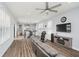 Open-concept living room with wood floors, modern furnishings, and abundant natural light from large windows at 7077 Antiquity Dr, Carmel, IN 46033