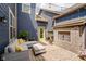Charming outdoor patio featuring stylish seating, a unique brick fireplace, and ambient string lights at 7077 Antiquity Dr, Carmel, IN 46033