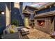 Cozy outdoor patio features a brick fireplace, comfortable seating, and string lights, creating a warm and inviting ambiance at 7077 Antiquity Dr, Carmel, IN 46033