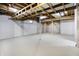 Unfinished basement offers potential for customization and extra living space with exposed ceiling and painted walls at 7513 Pine Royal Dr, Indianapolis, IN 46256