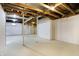 Spacious unfinished basement with exposed ceiling, concrete floor, and white painted walls, ready for customization at 7513 Pine Royal Dr, Indianapolis, IN 46256