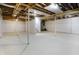 Large, unfinished basement with support beams and stairs provides ample room for storage or future renovation at 7513 Pine Royal Dr, Indianapolis, IN 46256