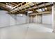 Unfinished basement featuring white walls, light floor, and open ceiling at 7513 Pine Royal Dr, Indianapolis, IN 46256