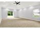 Spacious bedroom with carpet, tray ceiling, and large windows for natural light and backyard view at 7513 Pine Royal Dr, Indianapolis, IN 46256