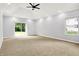 Bright bedroom with a modern ceiling fan, sliding glass doors to the backyard, and a large window at 7513 Pine Royal Dr, Indianapolis, IN 46256