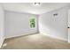 This carpeted bedroom has light grey walls and a single window at 7513 Pine Royal Dr, Indianapolis, IN 46256