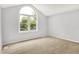 Bright bedroom features a large arched window with views of lush greenery at 7513 Pine Royal Dr, Indianapolis, IN 46256