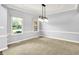 Bright dining room with neutral carpet and stylish lighting at 7513 Pine Royal Dr, Indianapolis, IN 46256