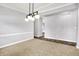 Spacious dining room with neutral carpet and contemporary light fixture at 7513 Pine Royal Dr, Indianapolis, IN 46256
