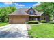 Charming brick home featuring an attached garage and well-maintained landscaping at 7513 Pine Royal Dr, Indianapolis, IN 46256