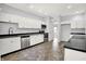 Updated kitchen with stainless steel appliances, white cabinets and black countertops and tile floors at 7513 Pine Royal Dr, Indianapolis, IN 46256
