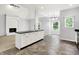 An eat-in kitchen featuring a large island, tile floors, and a view into the living room with a fireplace at 7513 Pine Royal Dr, Indianapolis, IN 46256