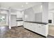Bright kitchen featuring white cabinetry, a black countertop island, and stylish tile flooring at 7513 Pine Royal Dr, Indianapolis, IN 46256
