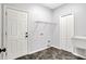 Functional laundry room with tiled flooring, sink, and wire shelving at 7513 Pine Royal Dr, Indianapolis, IN 46256