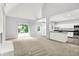 Open-concept living area with a fireplace, sliding glass doors and kitchen area at 7513 Pine Royal Dr, Indianapolis, IN 46256