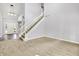 Spacious living room featuring neutral carpet and an adjacent staircase at 7513 Pine Royal Dr, Indianapolis, IN 46256