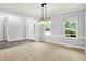Open-concept living room featuring neutral tones, large windows, and stylish lighting at 7513 Pine Royal Dr, Indianapolis, IN 46256
