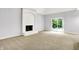 A living room with a white fireplace and access to the outdoor area at 7513 Pine Royal Dr, Indianapolis, IN 46256