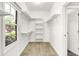 Bright walk-in closet with window and built-in shelving at 7513 Pine Royal Dr, Indianapolis, IN 46256
