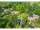 Aerial view of homes nestled among mature trees in a lush, green, residential neighborhood at 7575 Central Ave, Indianapolis, IN 46240