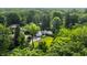 An aerial view of a single story home on a landscaped lot with mature trees at 7575 Central Ave, Indianapolis, IN 46240