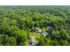 Aerial view showcasing lush green tree tops in a residential area and homes nestled among the trees at 7575 Central Ave, Indianapolis, IN 46240