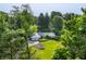Aerial view of a charming single-story home with an attached two car garage and mature trees at 7575 Central Ave, Indianapolis, IN 46240