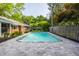 Spacious backyard featuring an in-ground swimming pool, stone patio, mature trees, and well-maintained landscaping at 7575 Central Ave, Indianapolis, IN 46240