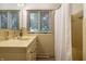 Traditional bathroom with a yellow tiled countertop, white shower curtain, and bright natural light at 7575 Central Ave, Indianapolis, IN 46240