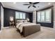 Comfortable bedroom with a ceiling fan, neutral walls, built-in shelves, and bright window shutters at 7575 Central Ave, Indianapolis, IN 46240